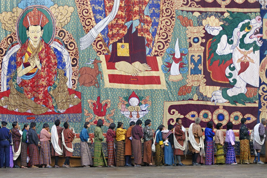 PILGRIMS QUEUEING FOR BLESSINGS AT THE BOTTOM OF A HUGE THANGKA OR THONGDREL, PUNAKHA TSECHU (FESTIVAL), PUNAKHA, BHUTAN